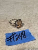 Front view of the vintage sterling silver ladies ring featuring a large rectangular faceted stone with amber-brown color.