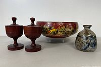 Front view of the lot showing two wooden jars, a round hand-painted Kashmiri bowl, and a small mottled pottery vase