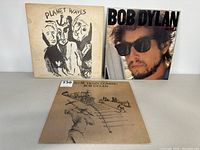 Front covers of Planet Waves, Infidels, and Slow Train Coming vinyl records showing condition and artwork.