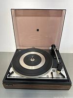 Front view of the Dual CS-16 turntable with dust cover open, showing tonearm and platter.