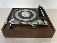 Side view of PE 3060 turntable showing wooden base and power switch.