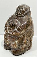 Front three-quarter view showing adult figure holding child