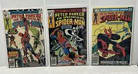 Three comic books in protective bags showing their front covers: #5 with Hitman and Vulture, #22 with Moon Knight, #58 with Beetle.