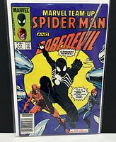 Front cover upright showing full artwork with black-costume Spider-Man, Daredevil and Black Widow