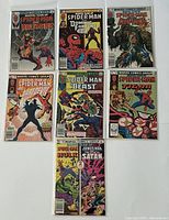 Top-down flat lay of seven Marvel Team-Up Spider-Man comic issues showing the covers prominently, including Wolverine and other characters.