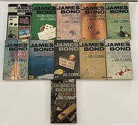 Overview shot showing all 11 paperbacks laid out in rows