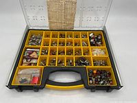 Full view of Stanley carrying case open showing multiple compartments containing assorted small vintage bulbs and packaging.