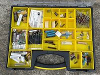 Top-down view of the Stanley yellow carrying case filled with various resistors and electronic components distributed in multiple compartments.