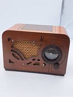 Full view of vintage Airline tabletop tube radio showing wood cabinet with decorative speaker grille and tuning dial.