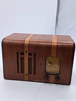 Front angle view of the rectangular wood grain Crosley radio showing vertical wood strips, tuning dial, and brand label.