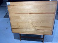 Front view of the wooden drawing table with rectangular 42x31 inch surface, showing natural wood grain and some surface wear.