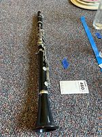 Full view of the Bundy clarinet laid out on carpet, showing the full length and bell shape.
