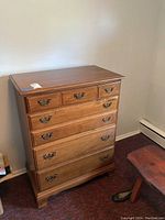 Front view of the Heywood-Wakefield wooden dresser with 6 drawers against a white wall.