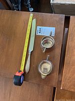 Sterling handle knife with floral patterns, measured with tape showing about 9.5-10 inches.