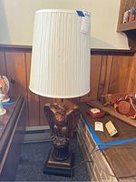 Full view of the vintage eagle table lamp showing the white pleated shade and eagle sculpture base.