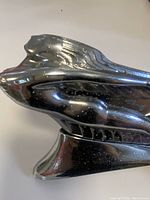 Close-up side view showing stylized figure and details on ornament