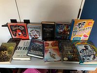 Photo showing 11 books arranged side by side, displaying titles and covers clearly for identification.