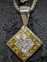 Front view of square pendant showing white and yellow diamond arrangement