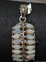 Top down view of the sterling silver pendant with two rows of marquise cut opal stones arranged side by side.