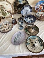 Full view of 21 pieces including decorative plates and a standing eagle figurine.