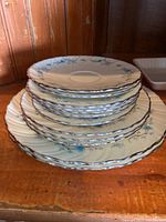 Stack of 12 Lenox china plates showing floral design and silver trim