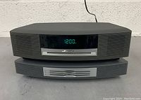 Front view showing digital clock display and CD slot