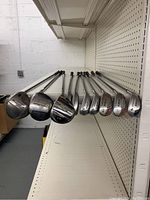 Photo of golf clubs showing club heads including Callaway Big Bertha, TaylorMade 200 Steel, and others.