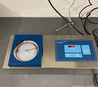 Full view of HemaPro 101 Monitor on stainless steel surface showing integrated chart recorder and front control panel with digital display.