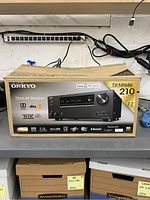 Box of the Onkyo TX-NR686 AV receiver showing product image and features.
