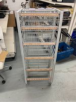 Front view of metal wire rack with labeled shelves for DVDs and CDs.