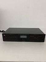 Front view of EQ-9000 equalizer showing dual frequency sliders and power switch.