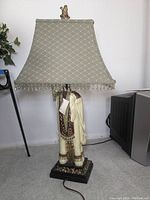 Elephant-theme table lamp showing the full view including sculpted elephant base and beaded lampshade with finial.