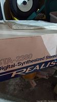 Close-up of original product box showing model STA-2380 and Realistic branding.
