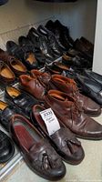 Photo of multiple pairs of men's leather shoes in size 9.5 including brown boots, black dress shoes, and tassel loafers.