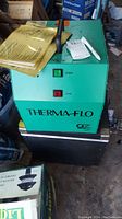 Green Thermaflo recovery system unit with START and STOP buttons, some dust and dirt on surface.