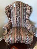 Front view of wing back armchair with animal print upholstery.