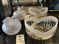 Front view of frosted apple perfume bottle with heart-shaped bowl and mirror reflection