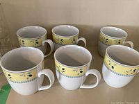 Front view of 6 Royal Doulton Blueberry pattern mugs arranged in two rows.