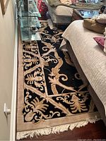 Image showing the full layout of the decorative rectangular rug between furniture on a hardwood floor.