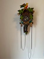 Full front view of the wooden cuckoo clock hanging on wall