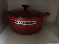 24 cm red Dutch oven showing exterior and Le Creuset logo