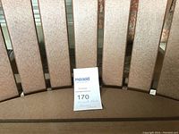 Top-down view of slatted back and seat with lot tag