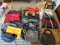 Photo of assortment of leather-like purses in multiple colors and sizes arranged on a surface