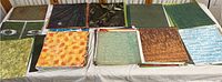 Top view of laid out 12x12 scrapbooking paper sheets with assorted patterns