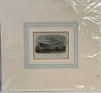 Full view of the framed etching print wrapped in plastic showing overall condition and framing.