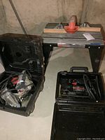 Photo showing the router table with router mounted on top and carrying case open with router inside.