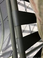 Close-up of the metal frame and support straps of the glider chair.