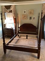 Full assembled bed frame without mattress, showing headboard, footboard, rails and posts