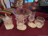 Full set of Waterford crystal serving items displayed: large bowl, creamer, sugar bowl with lid, shaker, and small pedestal bowl.