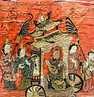 Close-up of silk embroidery art showing seated figure in traditional carriage with attendants and intricate thread details.